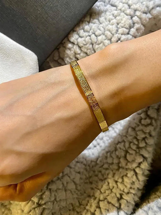 CartzyUae Ayatul Kursi cuff bracelet featuring intricate Islamic calligraphy on a sleek metal band.
